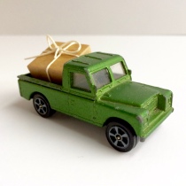 Miniture toy truck moving a gift